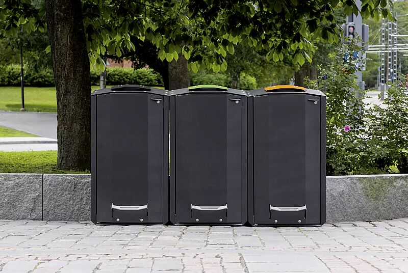 Abfallbehälter EKOCITY, Einwurfklappe in RAL 7021 schwarzgrau, RAL 6018 gelbgrün, RAL 1028 melonengelb, Stahlteile in Finbin Black 1945, ähnl. schwarz metallic, strukturiert