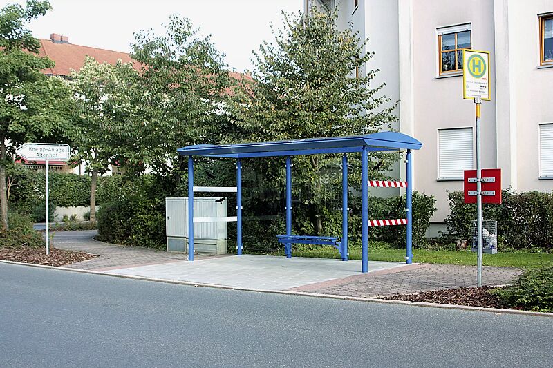 wartehalle-pluto__shoKAT0068530 Wartehalle PLUTO, Dachbreite x Dachtiefe 4800 mm x 2030 mm, Rück- / Seitenwände ESG, Klarglas, Beklebung bauseits, Drahtgittersitz TARVIS, Stahlkonstruktion in RAL 5017 verkehrsblau